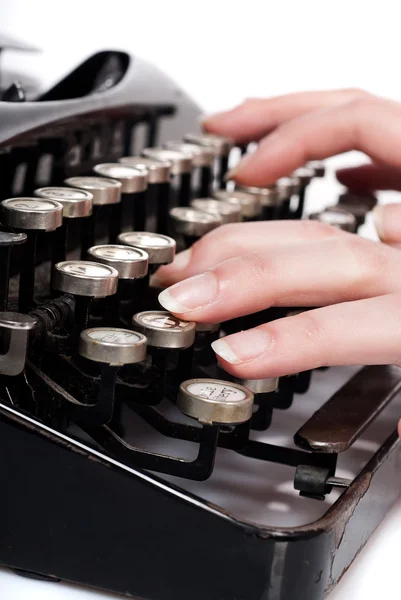Dedos en máquina de escribir vintage en blanco Imagen de archivo
