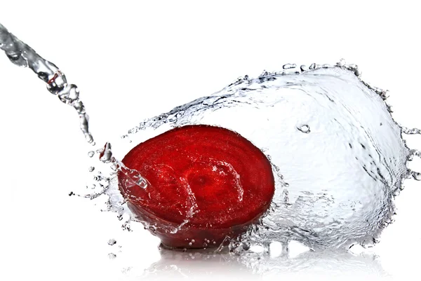 Красная свекла с брызгами воды изолированы на белом — стоковое фото