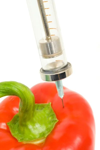 GMO - pepper with sticked aged syringe — Stock Photo, Image
