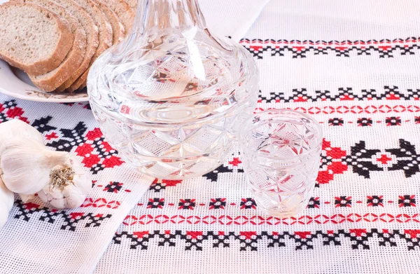 Vodka in decanter, bread and garlic — Stockfoto