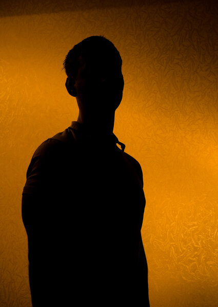 Leader - Back lit silhouette of man in the darkness