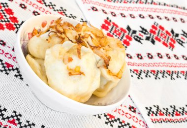 Ukrainian vareniki or dumplings with fried onion clipart