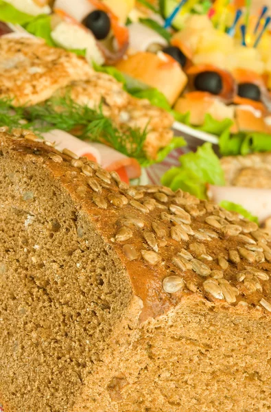 Cut Bread with seeds, meat and canape — Stock Photo, Image