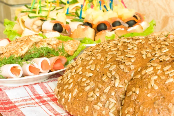 Meat, canape and Bread with seeds on table — Stock Photo, Image