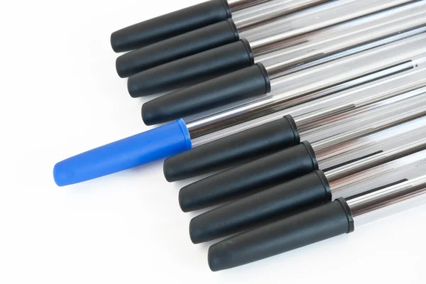 Black pens with a blue one — Stock Photo, Image