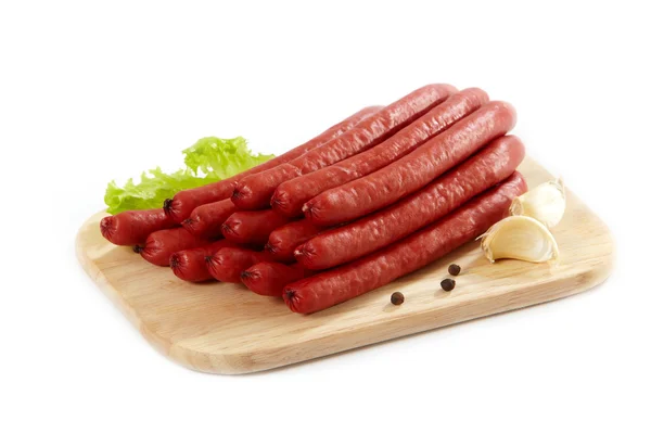 Smoked sausages on cutting board — Stock Photo, Image