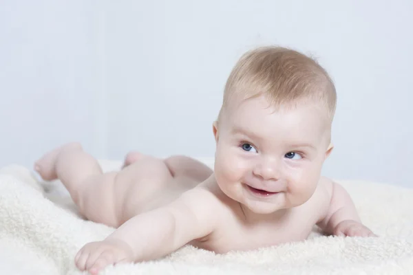 Baby lying on the bed — Stock Photo, Image