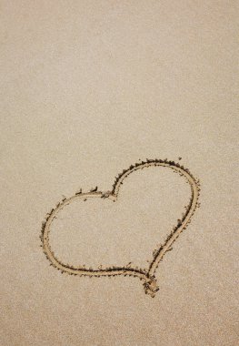 Heart on sea sand