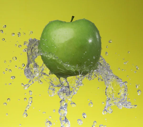 Grüner Apfel auf gelbem Hintergrund — Stockfoto