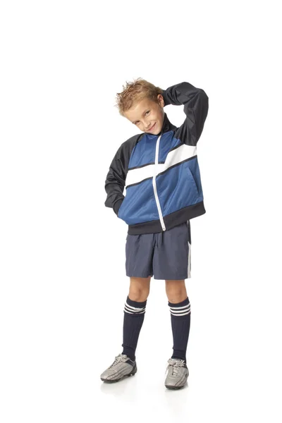 Ung gutt i fotballuniform stockbilde