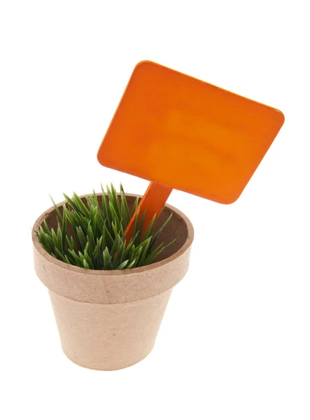 Pot van gras met levendige oranje teken — Stockfoto