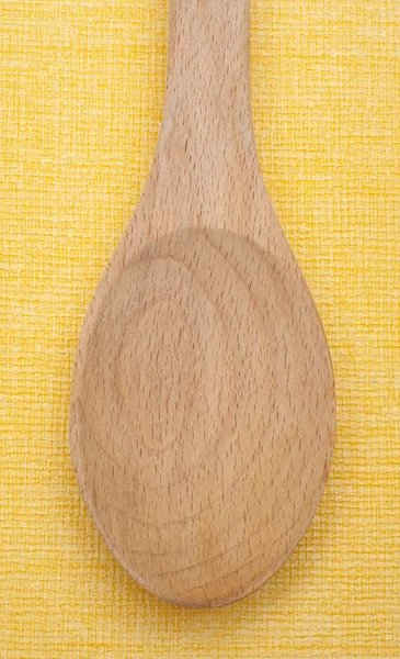 Cuchara de madera en amarillo — Foto de Stock