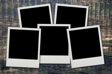 Polaroid frames on wood background clipart