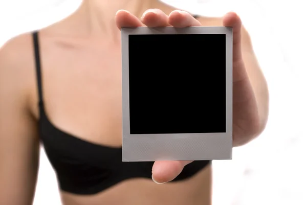 Young woman holds a polaroid — Stock Photo, Image