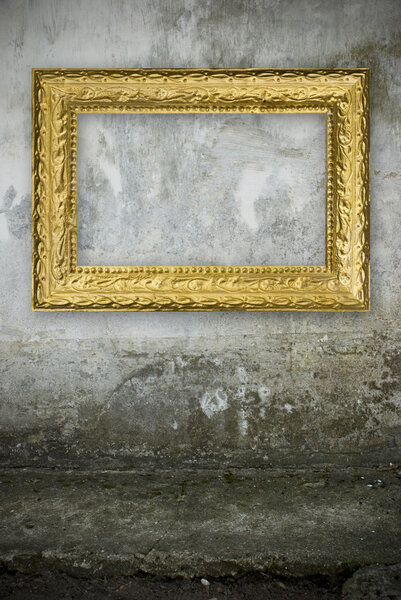 Old grunge wall with vintage gold frame
