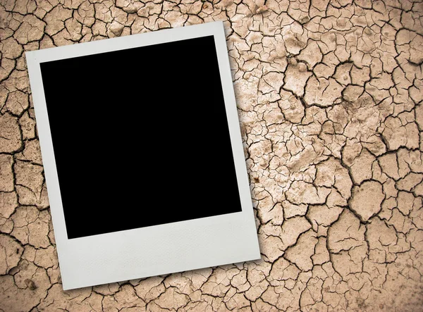 Stock image Photo card on cracked ground