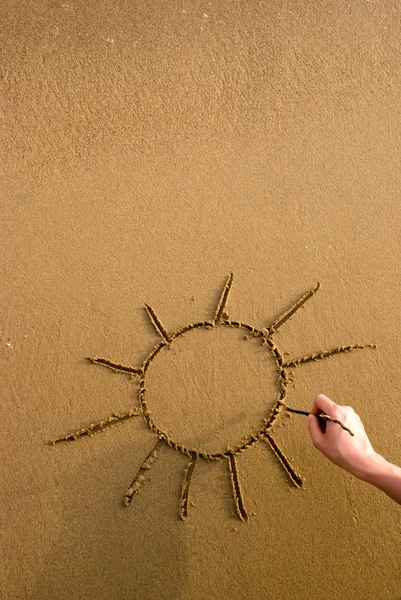 Güneş sembolü kumun üzerinde çizim — Stok fotoğraf