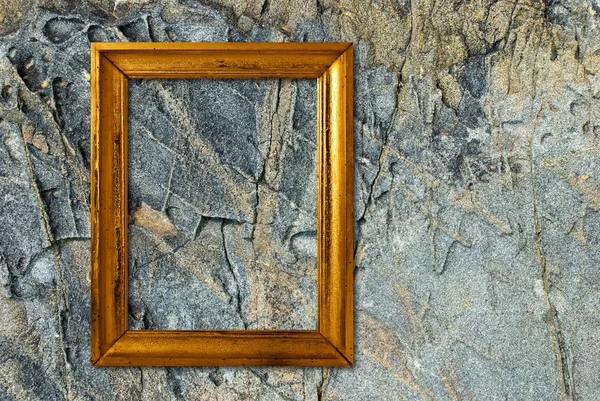 Marco de oro sobre un fondo de piedra — Foto de Stock