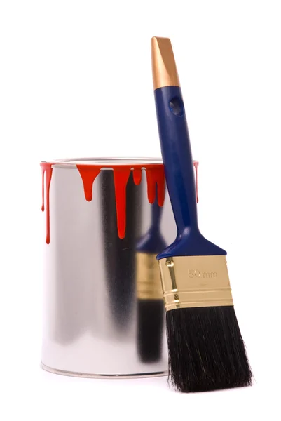 Can of red paint and professional brush on a whi — Stock Photo, Image