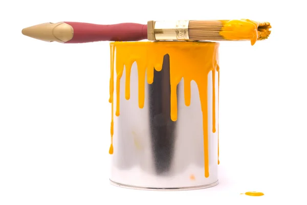 Can of yellow paint and professional brush on a — Stock Photo, Image