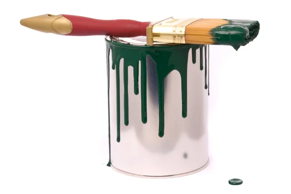 Can of green paint and professional brush on a w — Stock Photo, Image