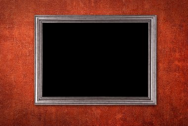 Silver frame on a red wall background clipart