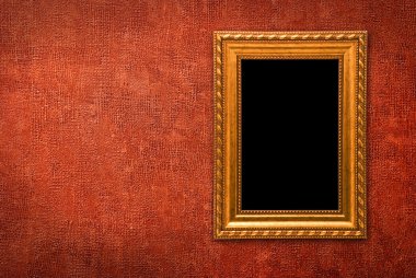 Gold frame on a red wall background clipart