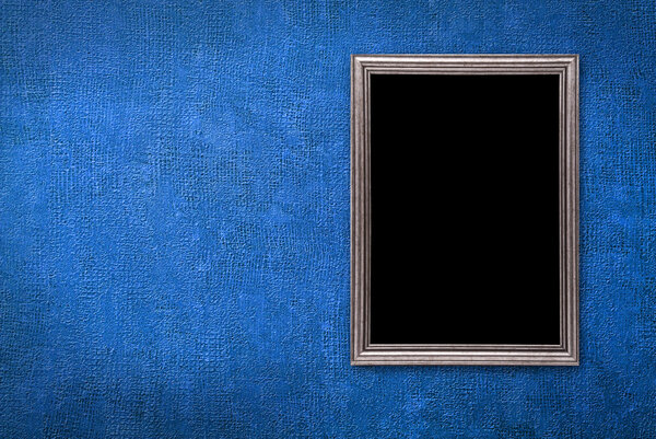 Silver frame on a old blue wall background