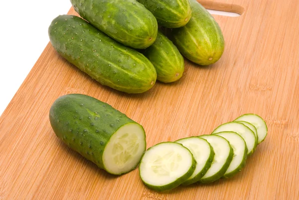 Fresh cucumbers on a chopping board — Stock Photo, Image