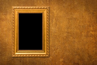 Gold frame on a yellow wall background clipart