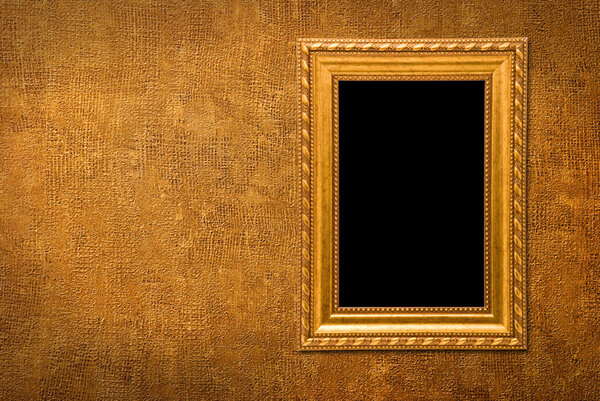 Gold frame on a yellow wall background
