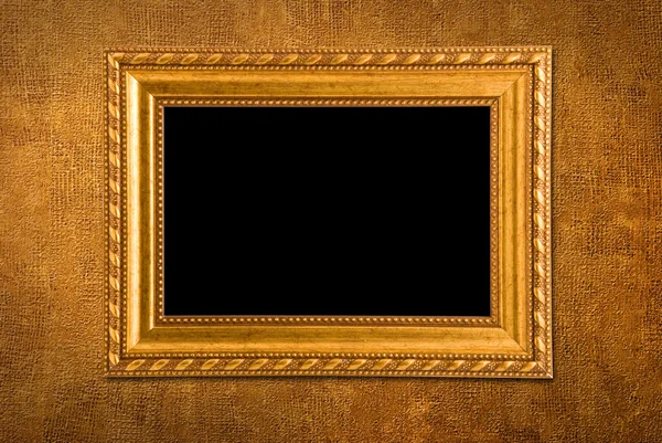 Gold frame on a yellow wall background — Stock Photo, Image