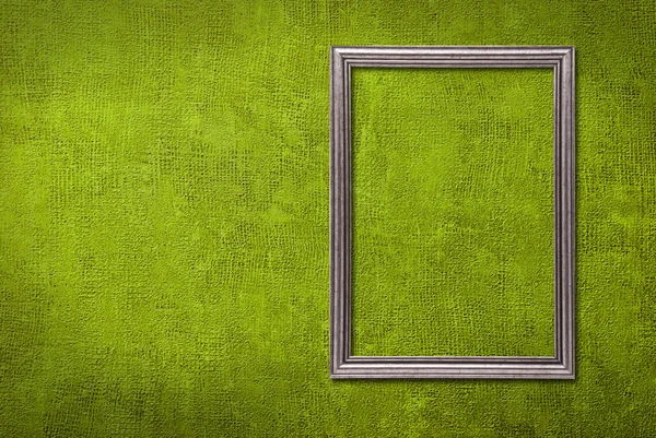 Silver frame on a green wall background — Stock Photo, Image