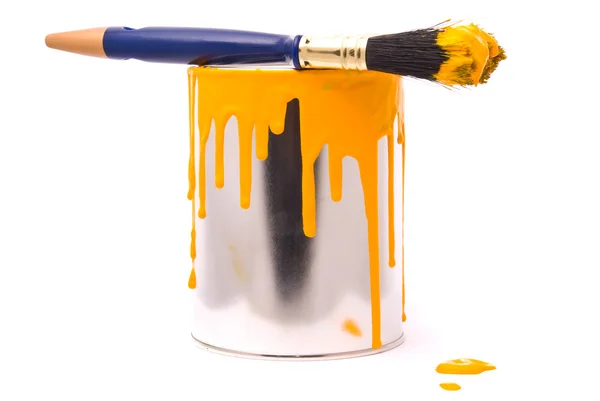 Can of yellow paint and brush — Stock Photo, Image
