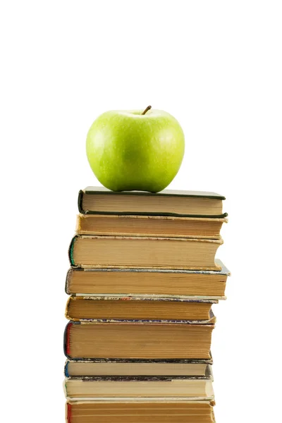Böcker och grönt äpple — Stockfoto
