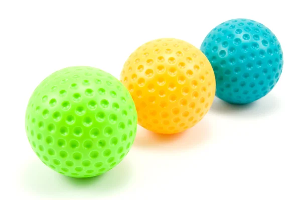 Três bolas de golfe coloridas — Fotografia de Stock