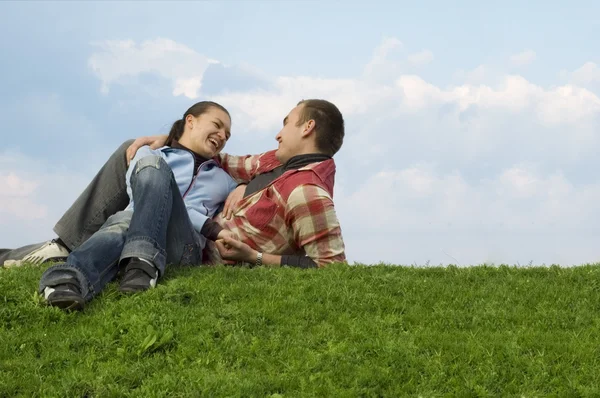stock image Young couple lying on the grass