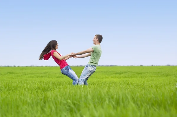 Couple holding by hands and whirling — Stock Photo, Image