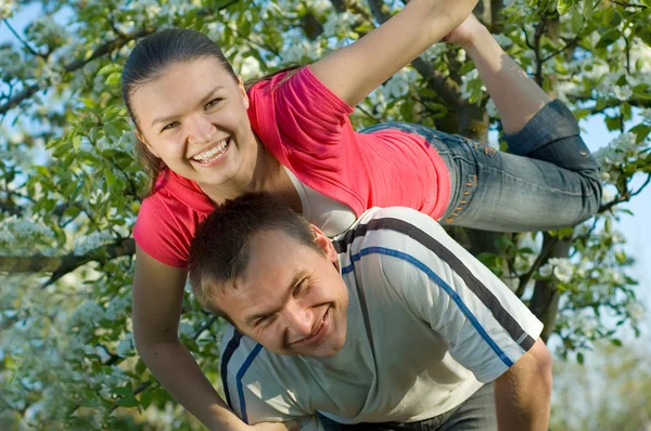 Young couple playing in a garden — Stock Photo, Image