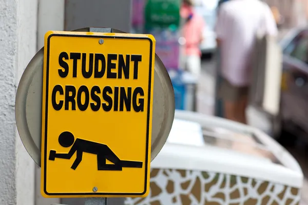 Warning sign "Drunken students crossing" Stock Photo