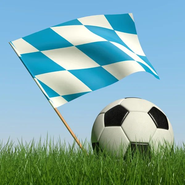 Ballon de football dans l'herbe et le drapeau de Bavière . — Photo