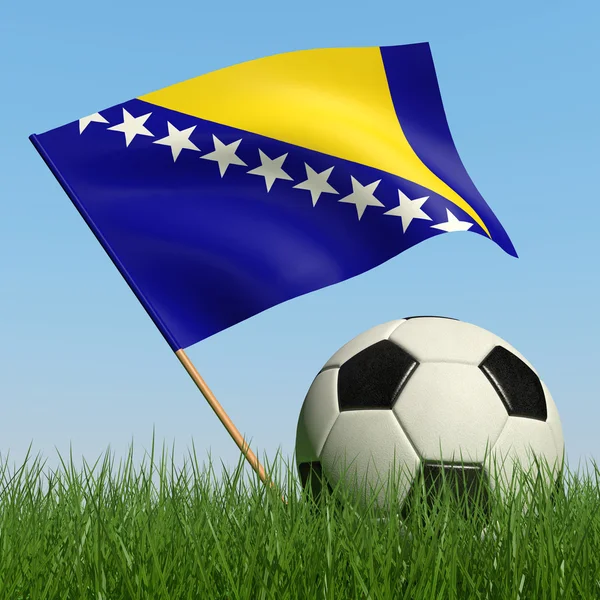 Bola de futebol na grama e bandeira da Bósnia e Herzegovina . — Fotografia de Stock