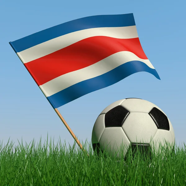 Pelota de fútbol en el césped y la bandera de Costa Rica —  Fotos de Stock