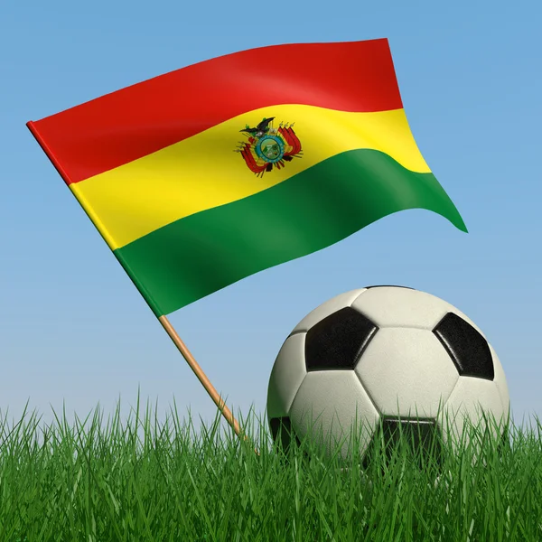 Ballon de football dans l'herbe et le drapeau de la Bolivie — Photo