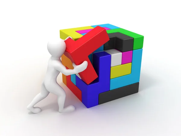 Mannen met een kubus opgebouwd uit blokken. puzzel — Stockfoto