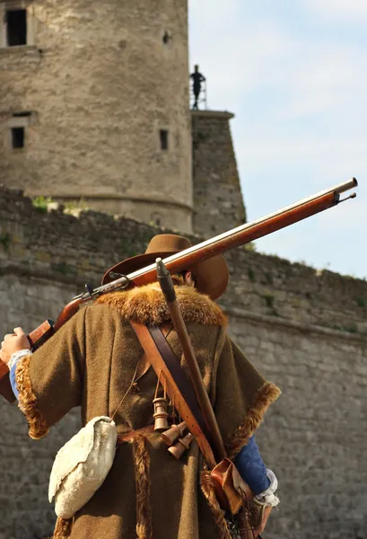 stock image Musketeer against the backdrop of the castle