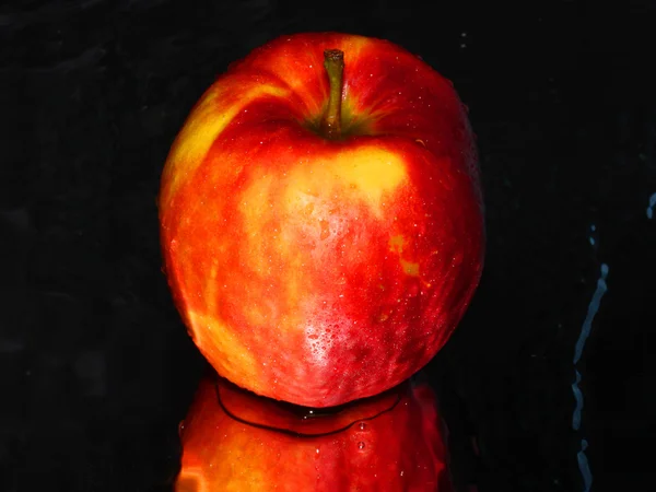 Red apple on black abstract background — Stock Photo, Image