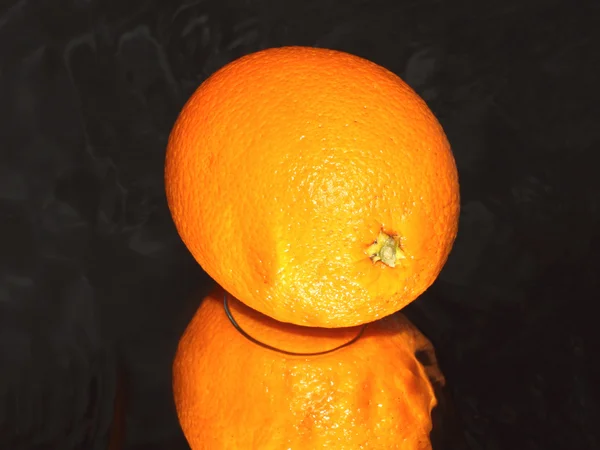 Orange on black background — Stock Photo, Image