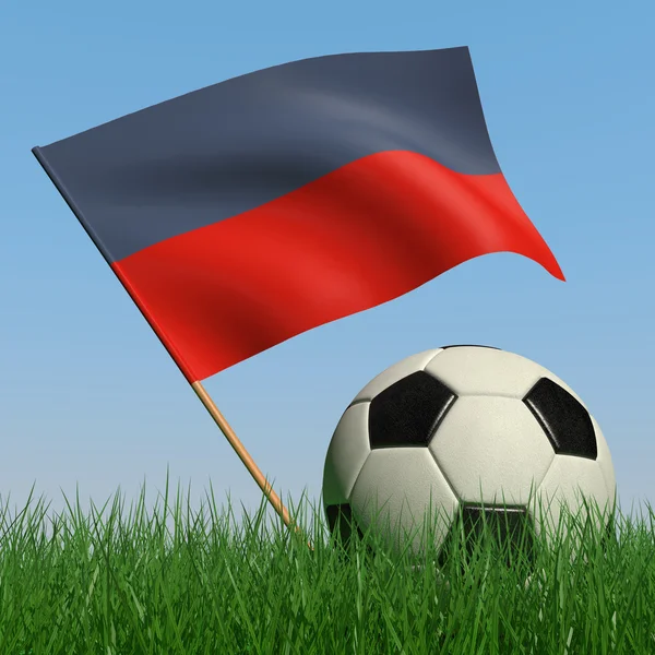 Fotbalový míč v trávě a vlajka haiti — Stock fotografie