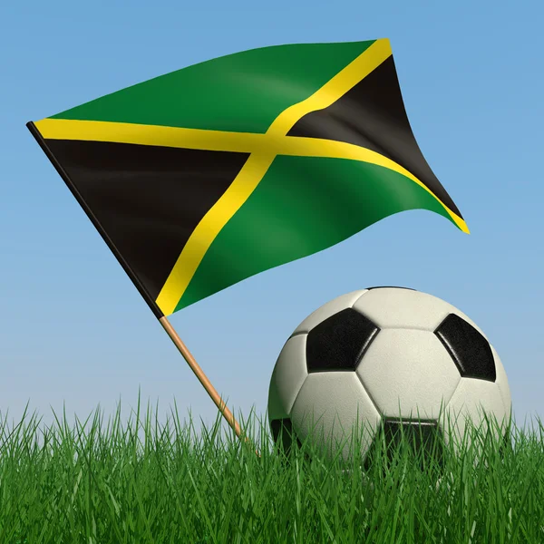 Pelota de fútbol en el césped y la bandera de Jamaica — Foto de Stock